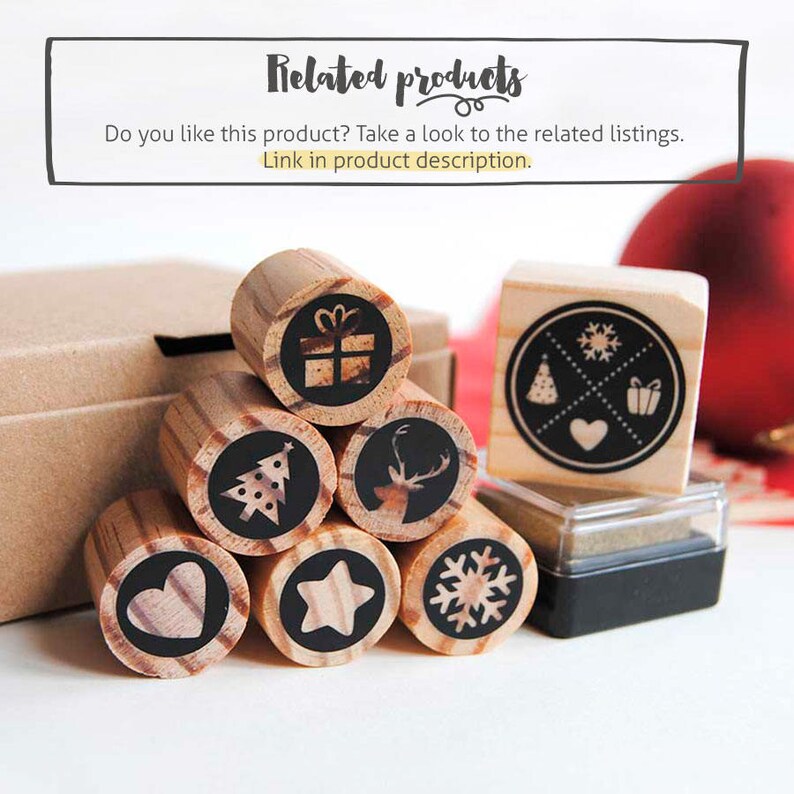 May include: A set of eight wooden Christmas stamps with various designs, including a Christmas tree, a reindeer, a star, a snowflake, a heart, a gift box, and a snowflake with a heart, a Christmas tree, and a gift box. The stamps are arranged in a pyramid shape on a white surface. There is also a black ink pad.