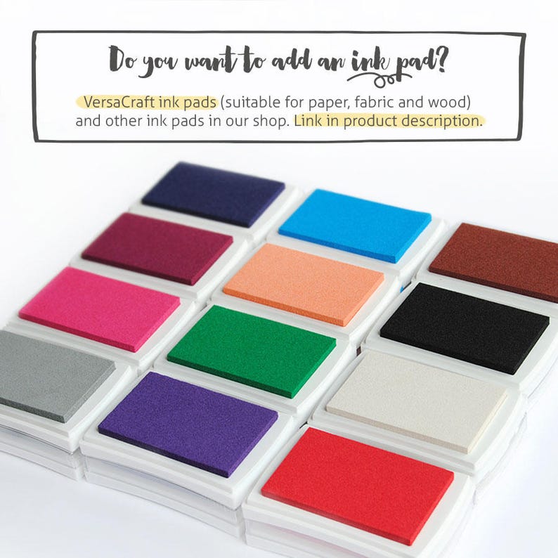 May include: A set of 12 ink pads in various colors, including red, orange, yellow, green, blue, purple, brown, black, gray, and white. The ink pads are arranged in a stack, with the white ink pad on top. The ink pads are labeled "VersaCraft ink pads (suitable for paper, fabric and wood)" and "Link in product description."
