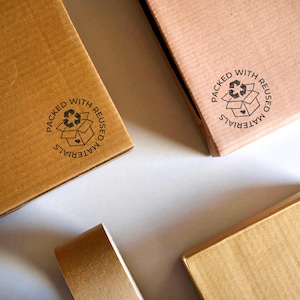 Rubber stamp for print on boxes wrapped with reused materials. Packed with reused materials stamp. Made in Barcelona by biterswit.