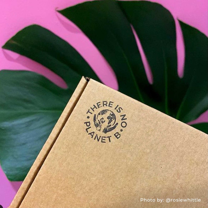 A close-up of a kraft cardboard box with an eco-friendly stamp, captured in a customer’s photo. The stamped design adds a personalized and sustainable touch to the packaging, making it perfect for small businesses that want to enhance their brand identity while maintaining an eco-conscious approach. The stamp’s clear, crisp impression demonstrates its quality and how it can be used on boxes, envelopes, and biodegradable shipping materials.
