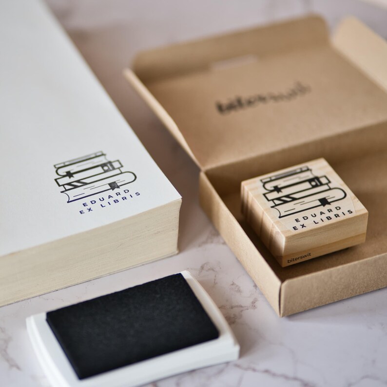 custom ex lbiris stamp with book pile illustration by biterswit