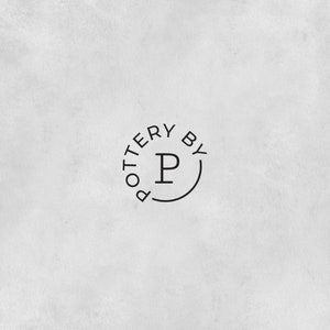 Puede incluir: Logotipo en blanco y negro con el texto "Pottery By" en un c&iacute;rculo alrededor de la letra "P".