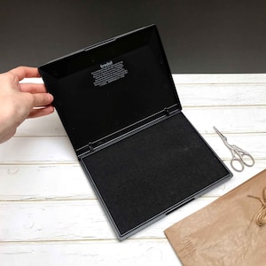 Large black ink pad for paper perfect for big logo stamps. Photo by biterswit.