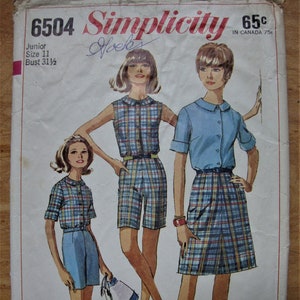May include: A vintage Simplicity sewing pattern for a junior size 11 dress with a 31 1/2 inch bust. The pattern features a plaid skirt and a plaid top with a Peter Pan collar. The pattern is from the 1960s and is in good condition.