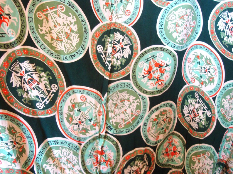 May include: A green fabric with a repeating pattern of white and red circles. Each circle contains a white design of a horse-drawn carriage with a crown on top. The background is a dark green.
