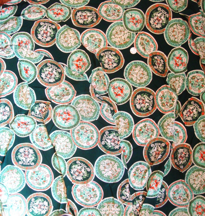 May include: Green fabric with a repeating pattern of white and red circular designs. Each circle features a stylized image of a horse-drawn carriage with a crown and other decorative elements.
