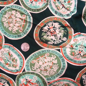 May include: Green fabric with a repeating pattern of white and red circles. Each circle contains a stylized image of a chariot pulled by horses. The fabric has a vintage look.