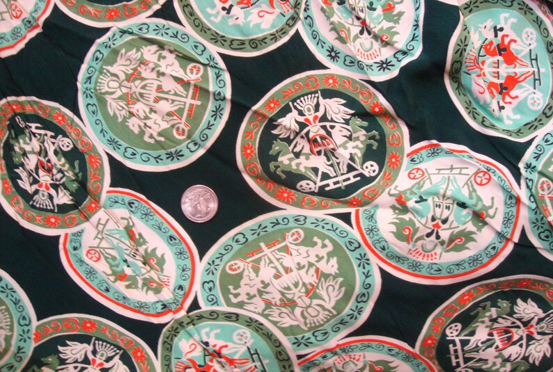 May include: Green fabric with a repeating pattern of white and red circles. Each circle contains a stylized image of a chariot pulled by horses. The fabric has a vintage look.