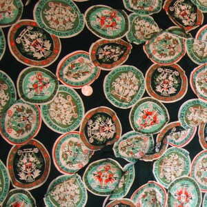 May include: Green fabric with a repeating pattern of white and red circular designs. Each circle features a stylized image of a carriage pulled by horses.