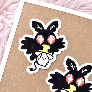 May include: Two black and white stickers of a cartoon moth holding a lightbulb. The moth has large red eyes with white sparkles. The lightbulb has a yellow base and a white face with a small smile and sparkles.