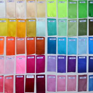 May include: A color chart of fabric swatches, each labeled with a number. The swatches are arranged in rows and columns, and the colors range from white to black.