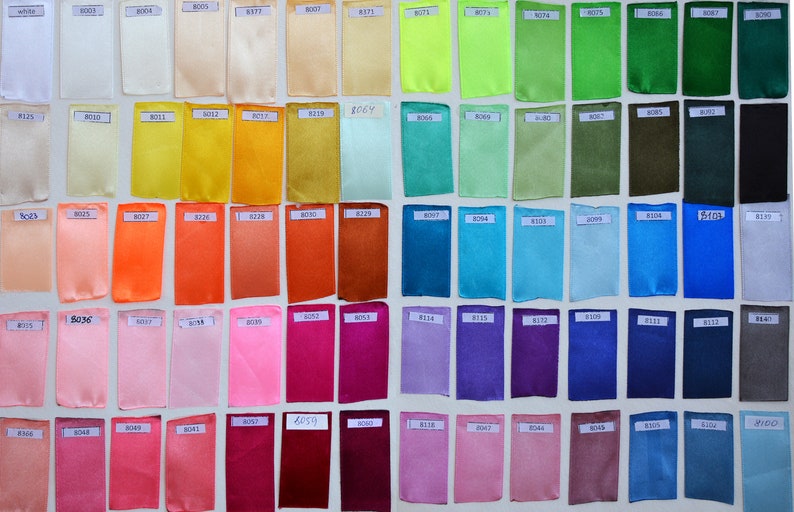 May include: A color chart of fabric swatches, each labeled with a number. The swatches are arranged in rows and columns, and the colors range from white to black.