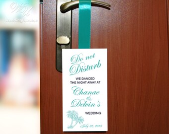 May include: White do not disturb sign with teal text and palm tree illustrations. The sign reads "Do not Disturb, We danced the night away at Chanae & Delvin's Wedding, July 22, 2018".