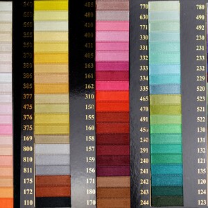 May include: A color chart of ribbon samples with numbers corresponding to each color. The colors range from white to black, with shades of pink, red, orange, yellow, green, blue, purple, and gray.