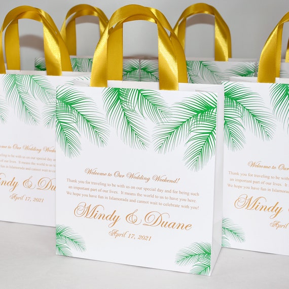 30 Tropical Wedding Welcome Bags with gold satin ribbon handles, palm leaves and names. Elegant Personalized Beach wedding favors for guests