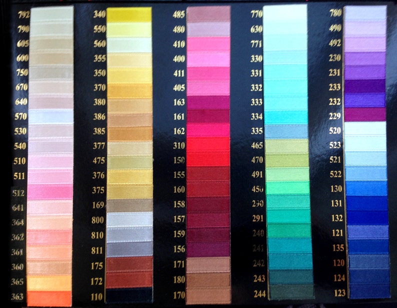 May include: A color chart of ribbon samples with numbers corresponding to each color. The colors range from light beige to dark blue.