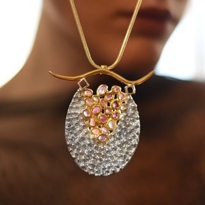 Avant-garde raw sapphire statement necklace with a bold, sculptural design, perfect for high-end couture and artistic fashion.