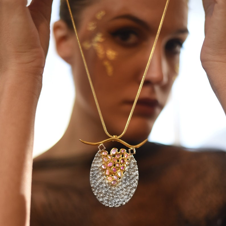 Avant-garde raw sapphire statement necklace with a bold, sculptural design, perfect for high-end couture and artistic fashion.