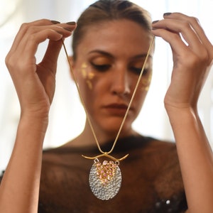 Avant-garde raw sapphire statement necklace with a bold, sculptural design, perfect for high-end couture and artistic fashion.