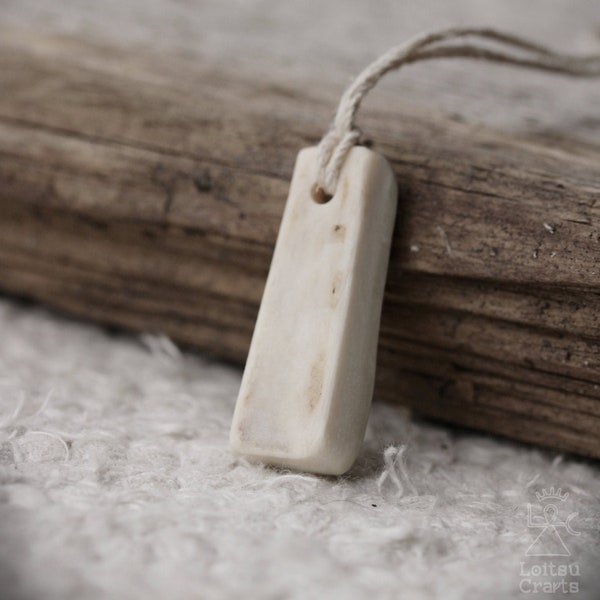 Carved moose bone amulet