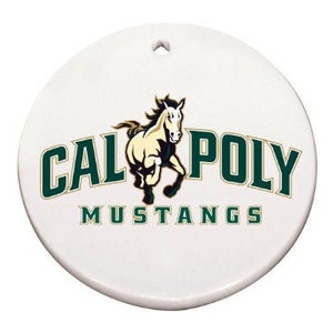 May include: White ceramic ornament with a hole at the top. The ornament features the text "CAL POLY MUSTANGS" in green and gold, with a running horse graphic in the center. The ornament is round.