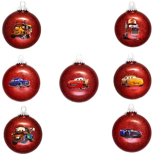 May include: Set of ten red Christmas ornaments featuring characters from the Cars movie franchise. The ornaments feature Lightning McQueen, Mater, and other characters from the movie.