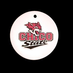 May include: White round ornament with a red and black mascot of a wildcat with the text "Chico State" in black and red.