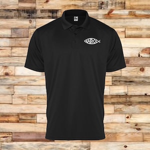 May include: Black polo shirt with a white fish design featuring the word "Kairos" inside the fish.