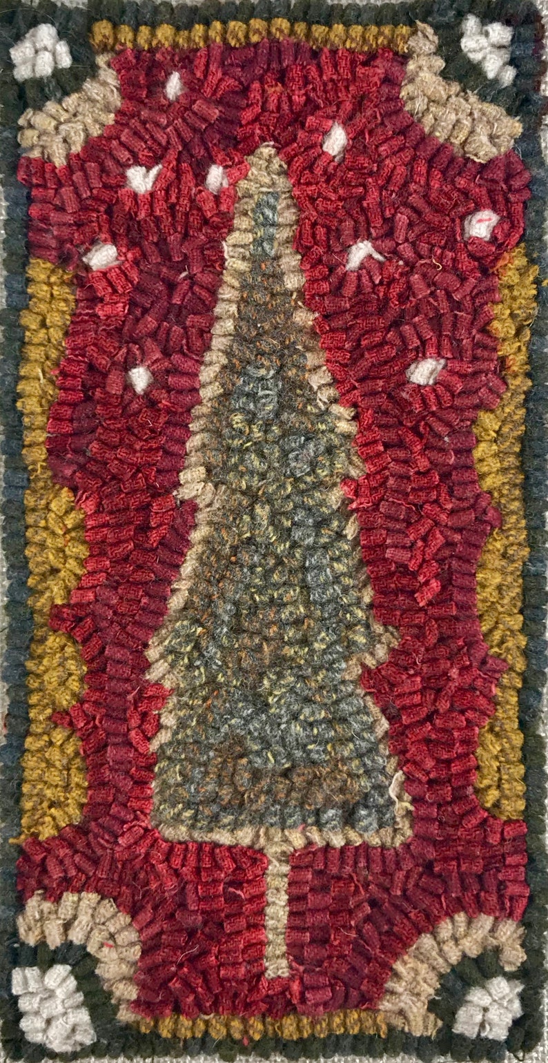 May include: Hand-hooked Christmas tree rug with a central evergreen tree design. The rug features a red background with white accents, a yellow border, and a green outer edge. The rug measures approximately 18 inches by 24 inches.