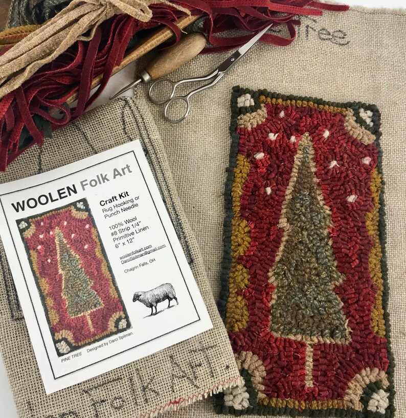May include: A craft kit for rug hooking or punch needle, featuring a "Pine Tree" design. The kit includes 100% wool strips and primitive linen, measuring 6" x 12". Additional supplies include scissors and a hooking tool. The kit is labeled "WOOLEN Folk Art".