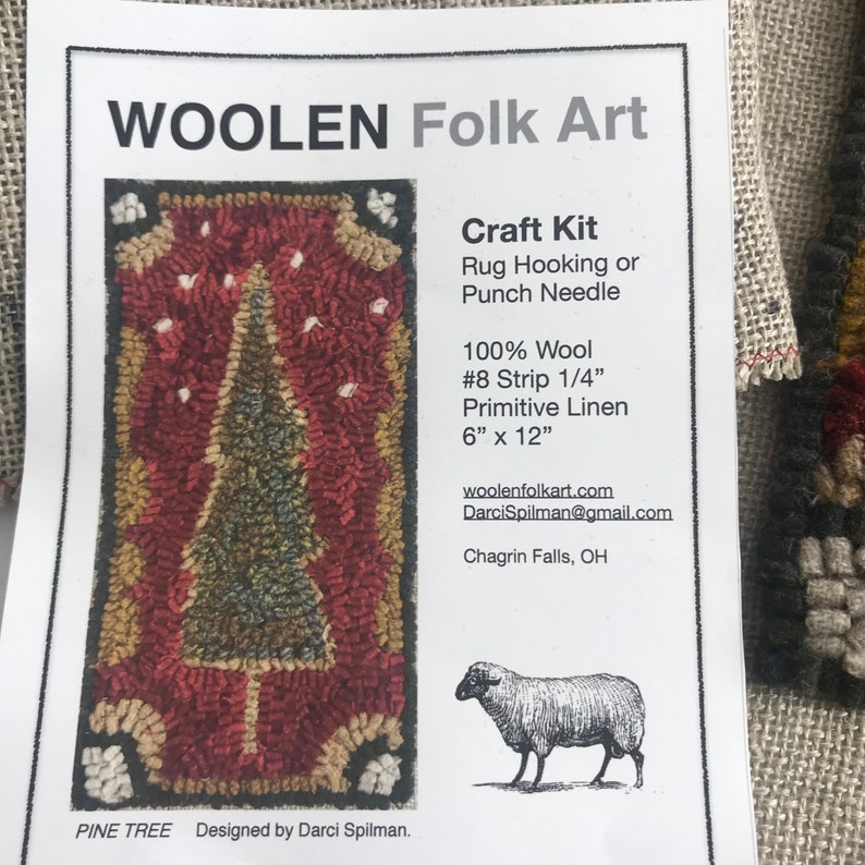 May include: A craft kit for rug hooking or punch needle featuring a pine tree design. The kit includes 100% wool, #8 strip 1/4" primitive linen, and measures 6" x 12". The text "WOOLEN Folk Art" and "PINE TREE" are visible.