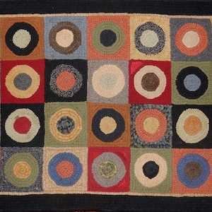 May include: A colorful rug with a geometric pattern of circles within squares. The rug is made of wool and has a variety of colors, including red, blue, green, yellow, and brown.