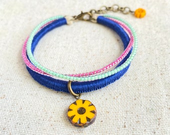 Navy blue bracelet with Czech glass flower beads and mint and fuchsia bead strands . 3 strand bracelet . choose your length + 1" chain