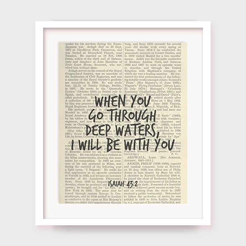 May include: A vintage book page with a black and white background. The page features a quote in black text: "When you go through deep waters, I will be with you." The quote is from the Bible, Isaiah 43:2.