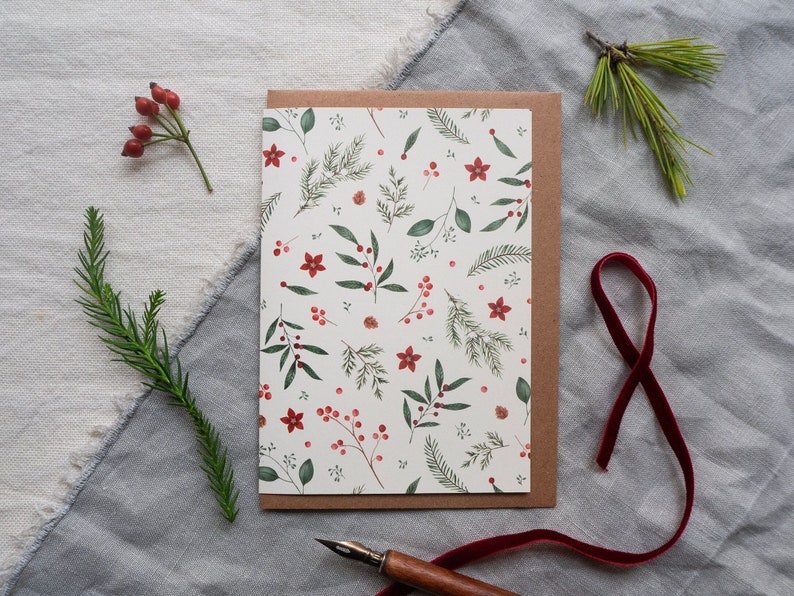 Christmas card with an all-over pattern of different branches, berries and small flowers