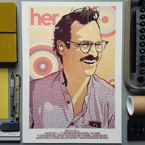 May include: A movie poster for the film "her" featuring a man with a mustache and glasses. The poster has a pink, white, and gray color scheme with a circular pattern in the background. The text "her" is in large, white letters at the top of the poster. The text "a Spike Jonze love story" is in smaller, white letters below the title.