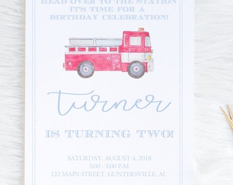 May include: A rectangular birthday invitation card featuring a watercolor illustration of a red fire truck. The text reads: HEAD OVER TO THE STATION IT'S TIME FOR A BIRTHDAY CELEBRATION! Turner IS TURNING TWO! SATURDAY, AUGUST 4, 2018 3:00 - 5:00 P.M. 123 MAIN STREET, GUNTERSVILLE, AL.