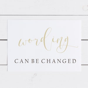 May include: White card with the word "wording" written in gold cursive script. Below the word is the text "CAN BE CHANGED" in black.
