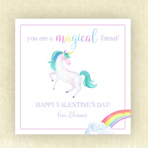 May include: A white unicorn with a rainbow mane and tail stands on a white background. The unicorn has a gold horn and closed eyes. The text "you are a magical friend!" is above the unicorn. Below the unicorn is the text "HAPPY VALENTINE'S DAY! love, Eleanor" and a rainbow with a white cloud.