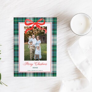 May include: A Christmas card with a green plaid background and a red bow. A family photo is in the center of the card with the text "Merry Christmas 2023 The Creek Family".