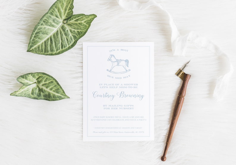 May include: A white card with blue text announcing a baby shower for Courtney Browning. The card features a rocking horse illustration and the text "It's a Boy! Due Mid May".