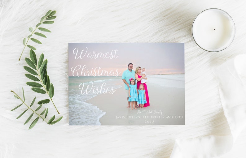 May include: A Christmas card with a family of five standing on a beach at sunset. The card reads "Warmest Christmas Wishes" and "The Michel Family" with the names of the family members listed below. The year 2018 is printed at the bottom of the card.