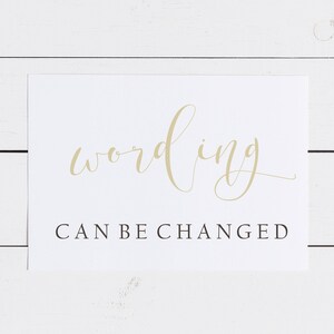 May include: White card with the word "wording" written in gold cursive script. Below the word is the text "CAN BE CHANGED" in black.