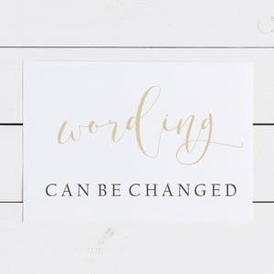 May include: White card with the word "wording" written in gold cursive script. Below the word is the text "CAN BE CHANGED" in black.