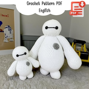 May include: Two white crochet figures, one large and one small, resembling a cartoon character. The figures have black eyes and a gray detail on the chest. The image includes the text "Crochet Pattern PDF English".