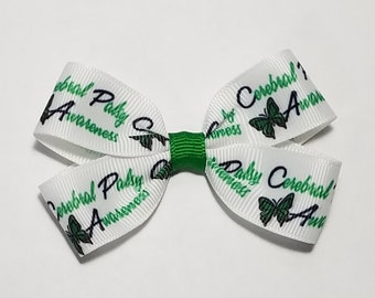 May include: White ribbon bow with green center, featuring a repeating pattern of butterflies and the text "Cerebral Palsy Awareness".
