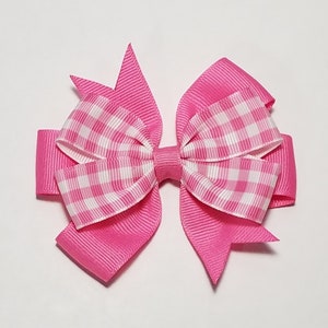 May include: A pink and white gingham bow with a pink satin ribbon.