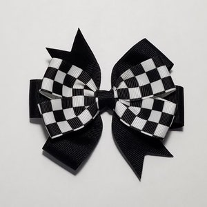 May include: Black and white checkered ribbon hair bow with black ribbon accents.