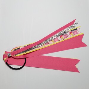 May include: Pink, yellow, and silver ribbon hair tie with a sparkly rhinestone accent. The ribbon has the text "Little Miss Third Grade" printed on it.