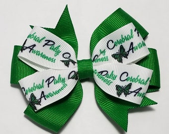 May include: Green and white ribbon bow with the text "Cerebral Palsy Awareness" and a butterfly design.